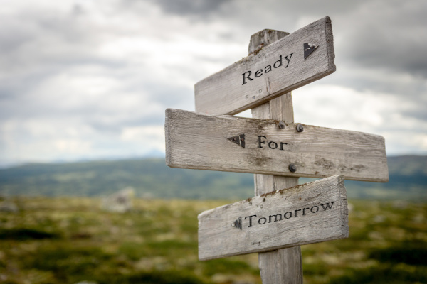 A sign wth directional arrows saying, "Ready, For, Tomorrow."